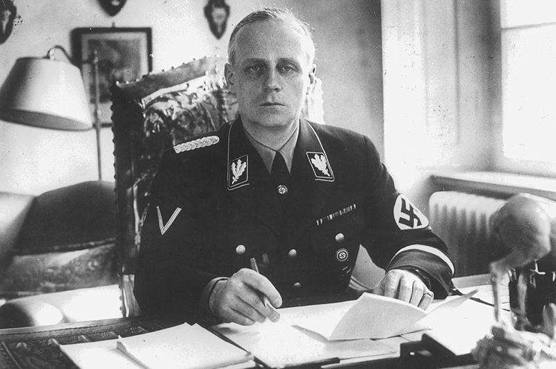 Nazi Reich Foreign Minister Joachim von Ribbentrop in uniform at his desk.